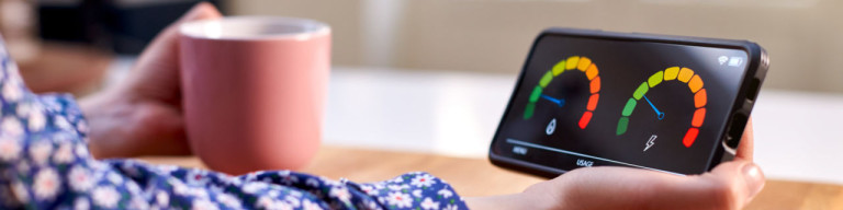 Frau liest digitale Stromverbrauchsanzeige